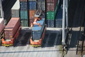 a train yard with cargo containers and train tracks
