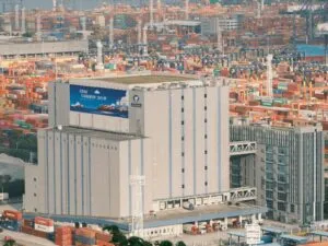 a forklift is moving a large stack of shipping containers
